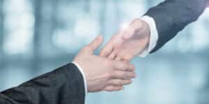 news-two-businessmen-reaching-for-a-handshake